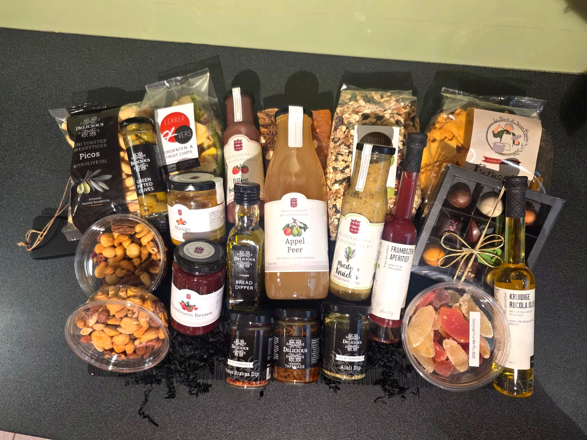 Cadeaupakket met appel-perensap, bonbons, olijfolie, noten en gedroogd fruit